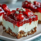 Sweet and salty strawberry pretzel salad bars with creamy cheesecake topped with fresh fruit.
