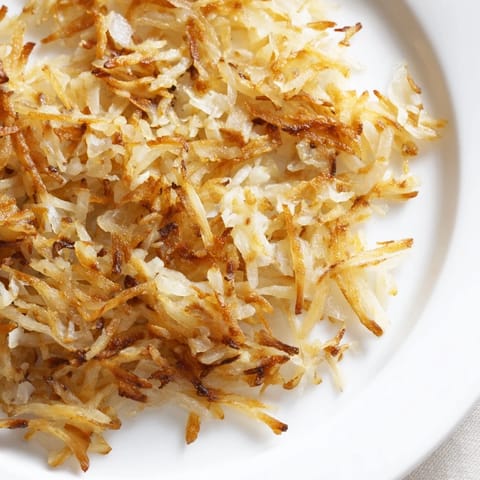 Golden, crispy pan-fried hash browns, a classic American breakfast side, ready to enjoy.
