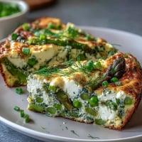 Spring Frittata with Asparagus, Peas and Goat Cheese, a vibrant brunch dish with fresh vegetables and creamy cheese.